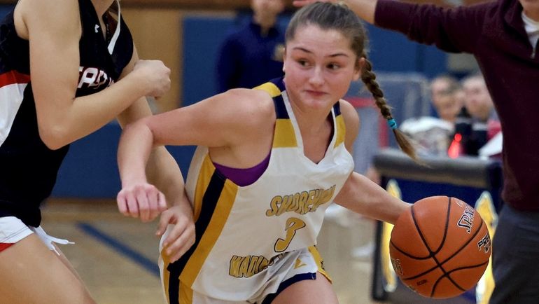 Shoreham-Wading River guard Sophie Costello drives to the outside in...