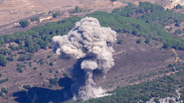 Smoke rises from an Israeli airstrike on the Mahmoudieh mountain,...