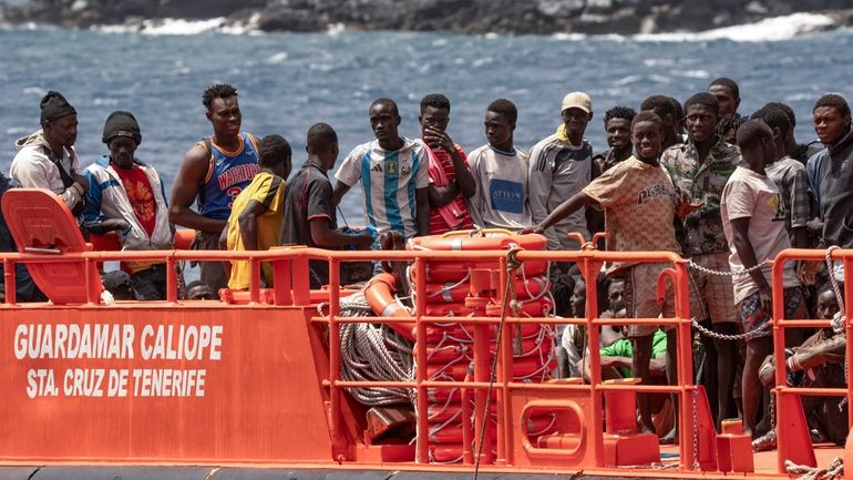 Migrants disembark at the port of on "La Estaca" in...