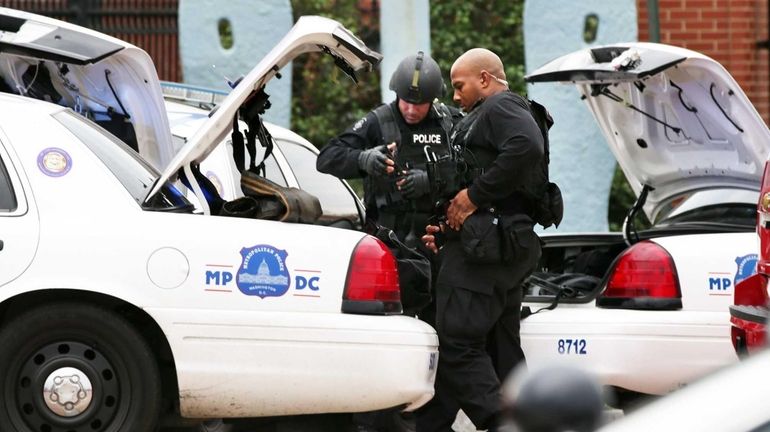 Two DC Metro Police officers put their gear up as...