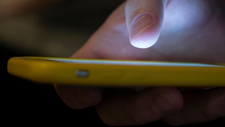 A man uses a cell phone in New Orleans on...