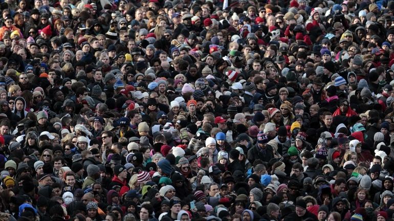 The crowd watches outside the Capitol during the U.S. presidential...