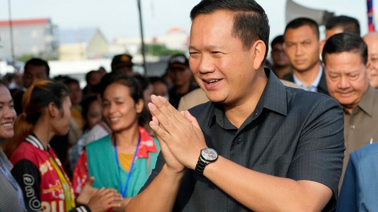 Cambodian Prime Minister Hun Manet greets garment workers at Prey...