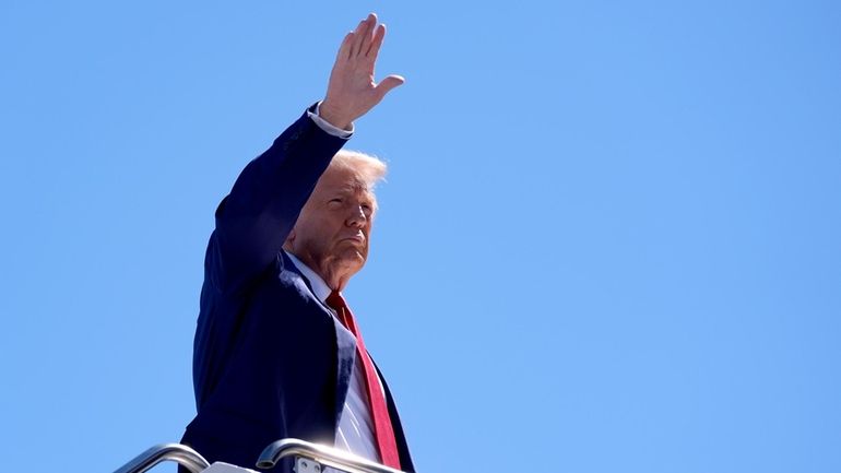 Republican presidential nominee former President Donald Trump waves as he...