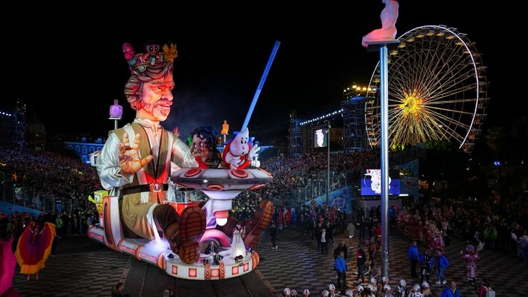 A carnival float depicting a king parades through Place Massena...