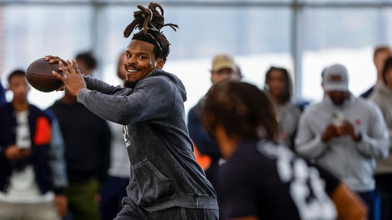 Former NFL and Auburn quarterback, Cam Newton, throws a pass...