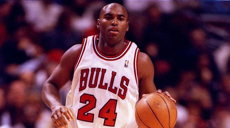 Scott Burrell of the Chicago Bulls drives the ball down...