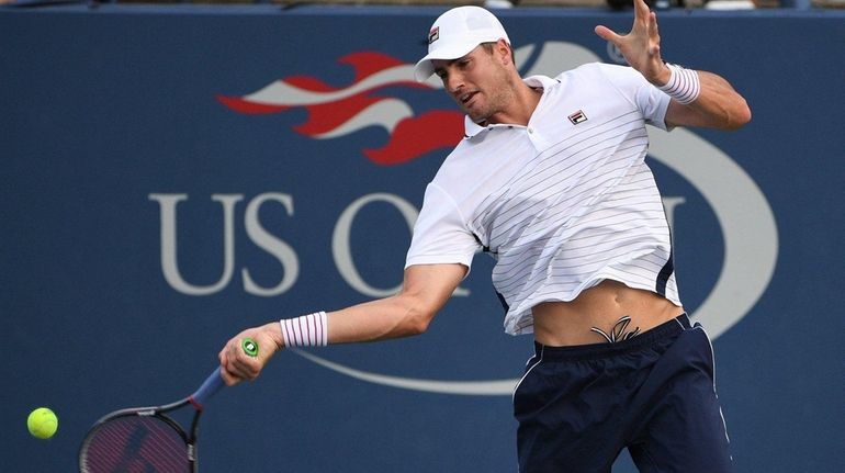 John Isner of the United States returns to Kyle Edmund...