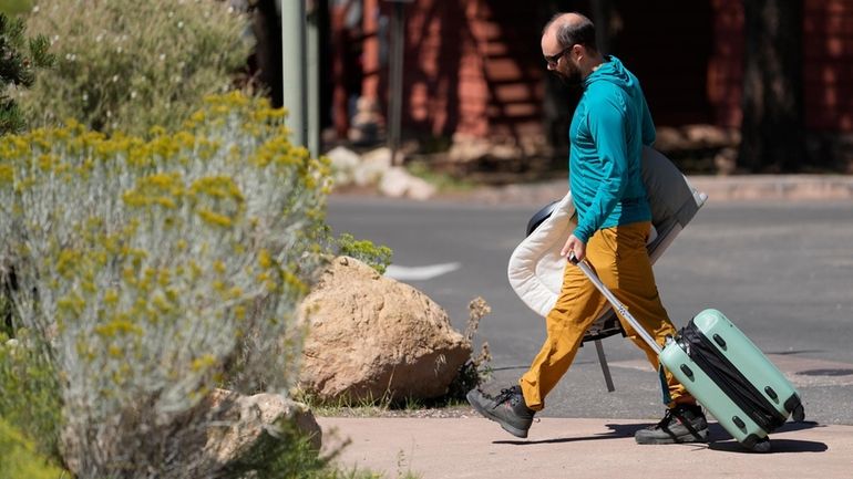 A guest leaves Bright Angel Lodge, Thursday, Aug. 29, 2024,...