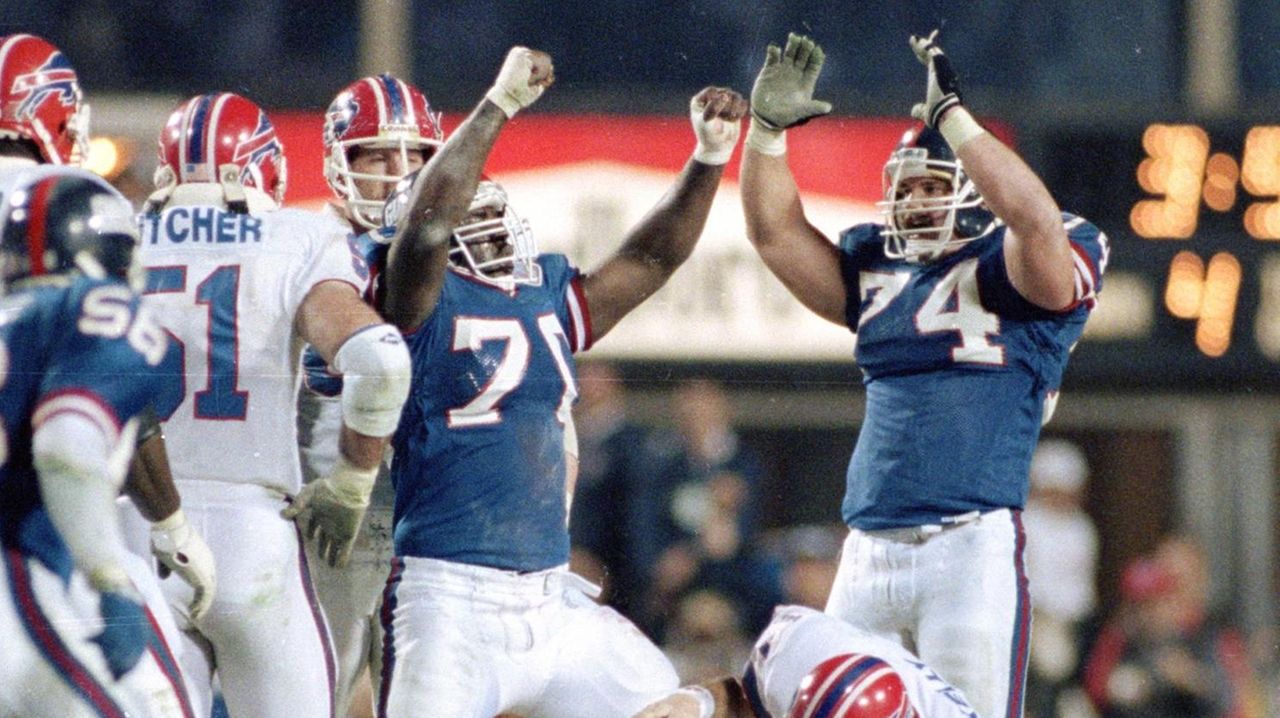 Leonard Marchall (70) and Erik Howard (74) of the New York Giants celebrate  the sack of Buffalo Bills quarterback Jim Kelly (12) in the third quarter  of SUper Bowl XXV Sunday, Jan.