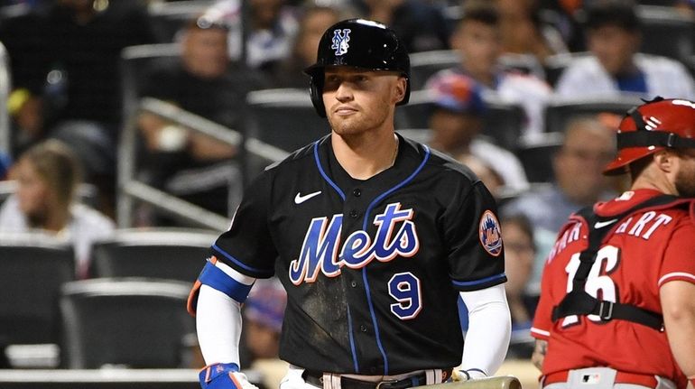 New York Mets center fielder Brandon Nimmo reacts after he...