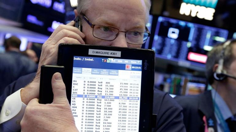 Trader Dennis Maguire works on the floor of the NYSE,...