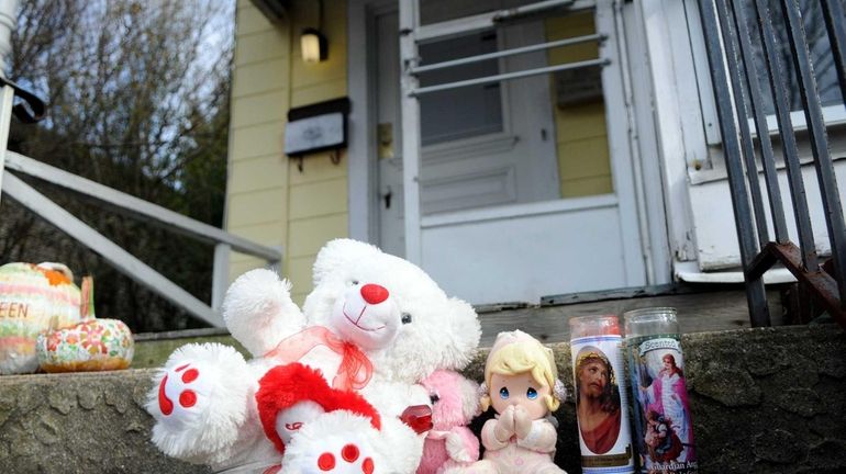 Stuffed animals and candles have been placed in front of...