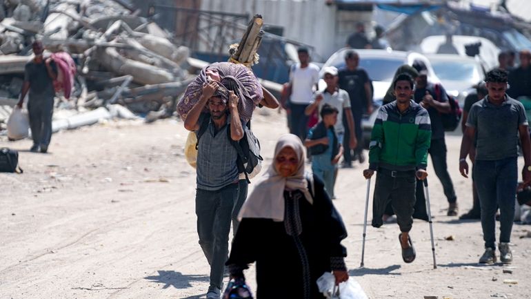 Palestinians displaced by the Israeli air and ground offensive on...