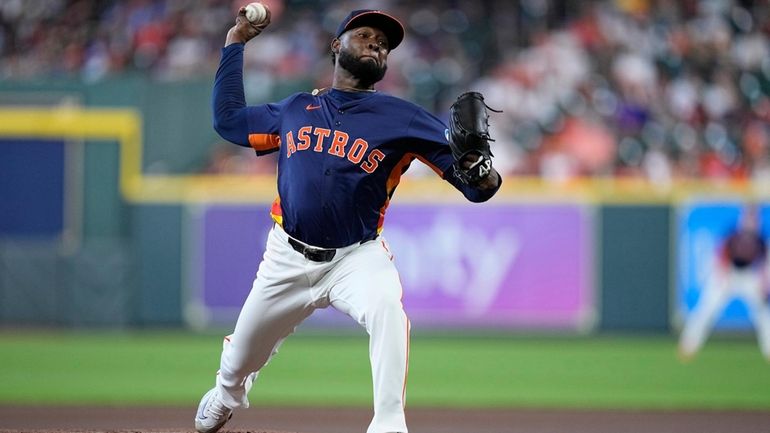 Houston Astros starting pitcher Cristian Javier delivers during the first...