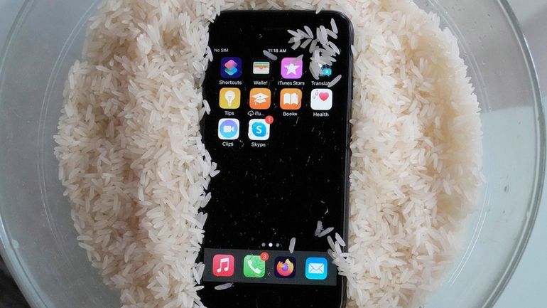 A view of a wet smartphone placed in a bowl...