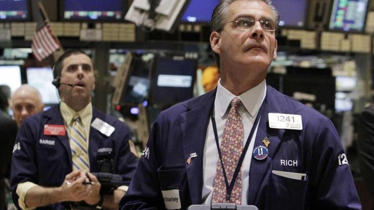 Traders work on the floor of the New York Stock...