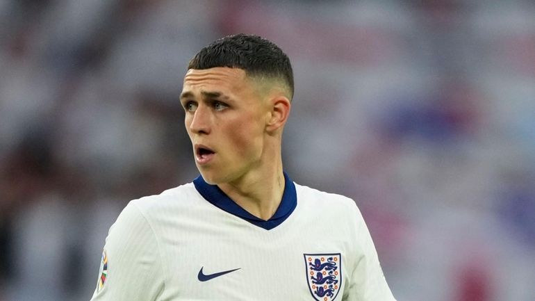 England's Phil Foden looks on during a Group C match...