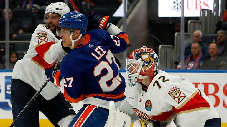 Anders Lee of the New York Islanders for position against...