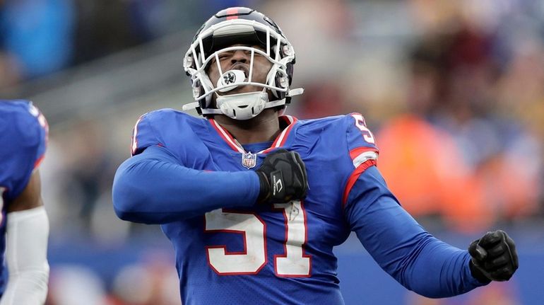 Azeez Ojulari and Jason Pinnock of the Giants react after a defensive stop...