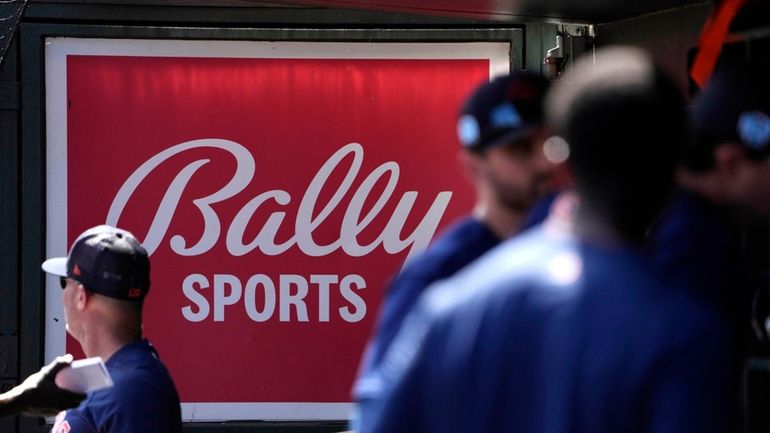 A Bally Sports sign hangs in a dugout before a...