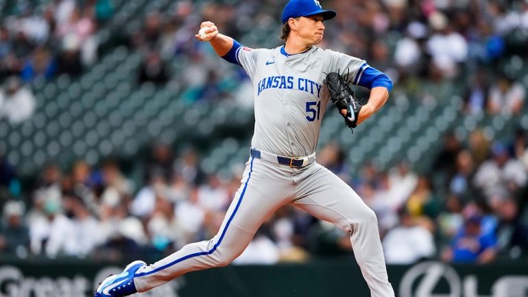 Kansas City Royals starting pitcher Brady Singer throws against the...