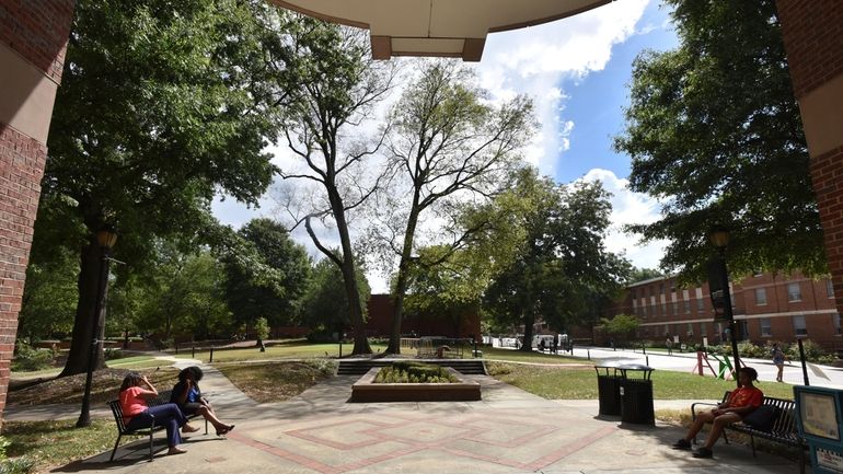 In this Sept. 26, 2018, file photo, students sit on...