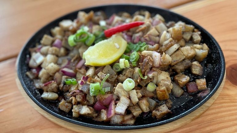 A platter of sizzling sisig at Kusinera, new to East...