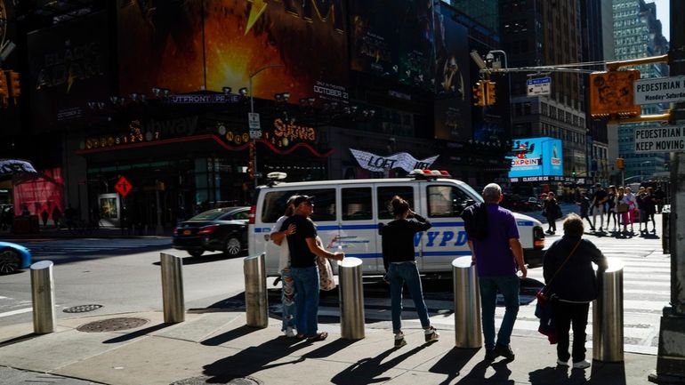 NYPD officers go on patrol around Times Square as tourists visit...