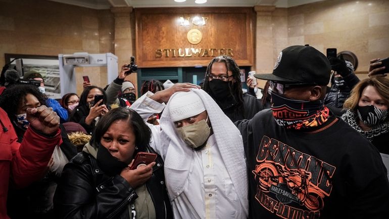 Myon Burrell is surrounded by family upon his release from...