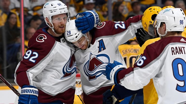 Colorado Avalanche center Nathan MacKinnon (29) celebrates with left wing...