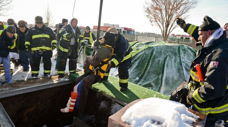 East Farmingdale firefighters rescue a man who fell into a...