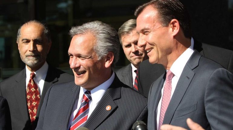 Nassau County Executive Edward Mangano, left, stands beside Nassau County...