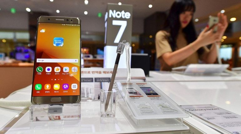 A woman tests a Samsung Galaxy Note7 smartphone at a...