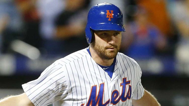 Daniel Murphy #28 of the New York Mets reacts as...