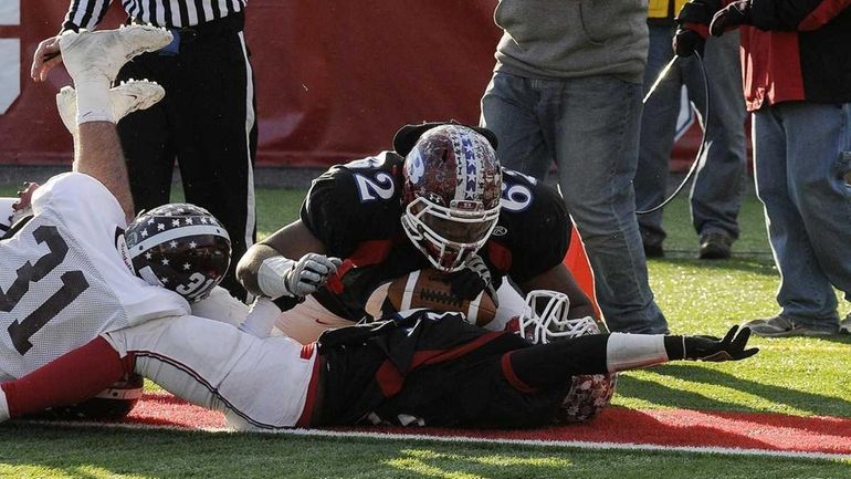 Bellport's 62 Ryan Sloan looks over and congratulates Travis Houpe...