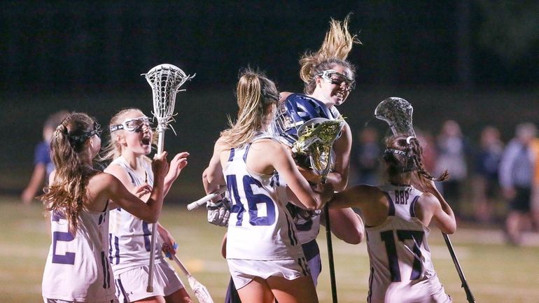 Bayport Blue Point celebrates their win during the Suffolk High...