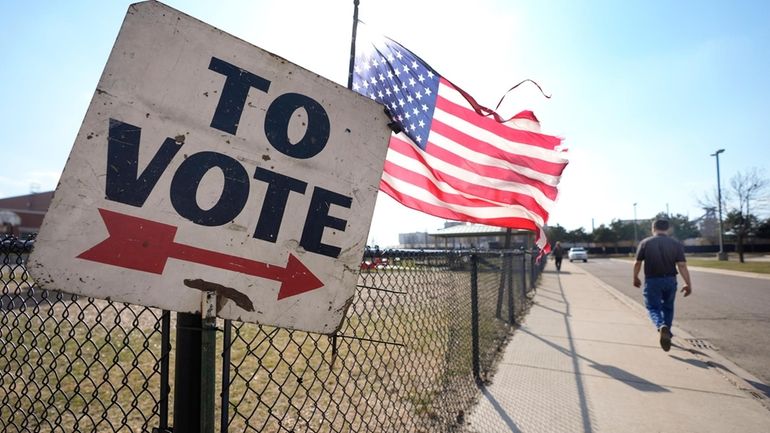 A voter walks to a Michigan primary election location in...