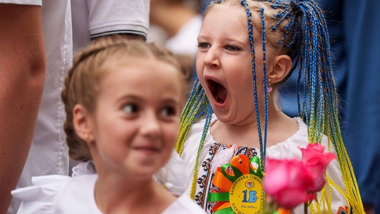 Children attend the traditional ceremony for the first day of...