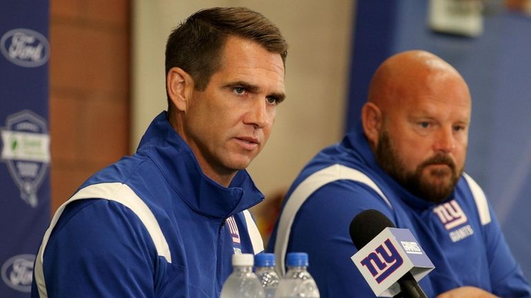 New York Giants general manager Joe Schoen (left) speaks to...