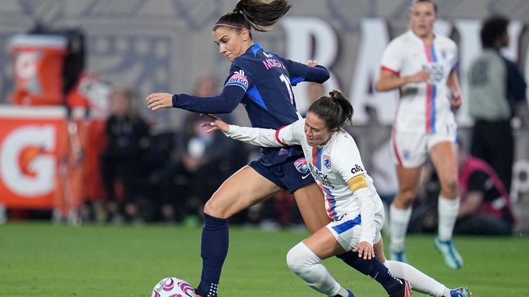 San Diego Wave forward Alex Morgan, left, controls the ball...