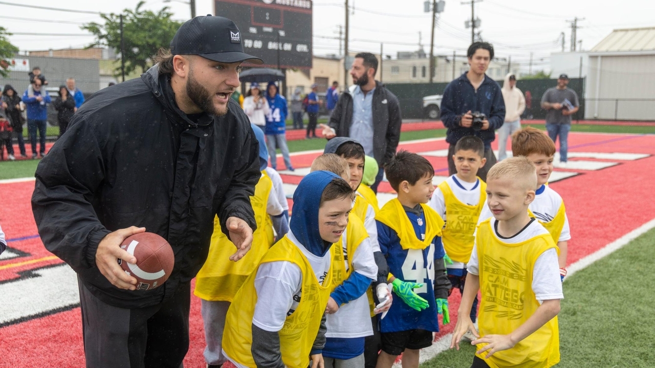 Giants' Cam Skattebo greets kids at Hampton Stadium in Mineola