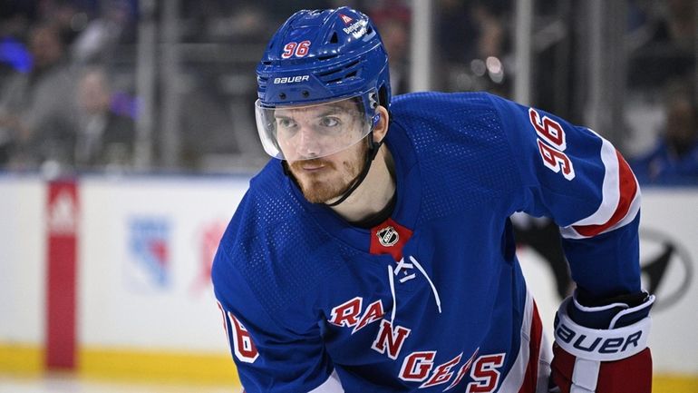 New York Rangers center Jack Roslovic sets before a face...