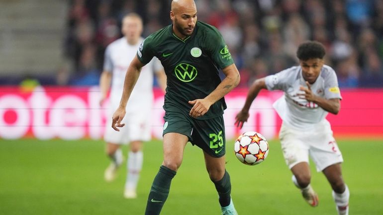 Wolfsburg's John Brooks runs with the ball during the Champions...