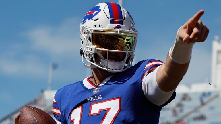 Bills quarterback Josh Allen gestures while warming up prior to...