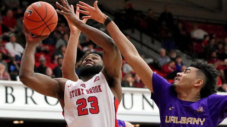 Stony Brook guard Andrew Garcia gets fouled on the shot...