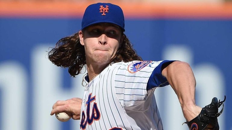 New York Mets starting pitcher Jacob deGrom delivers a pitch...