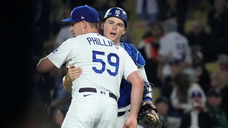 Los Angeles Dodgers relief pitcher Evan Phillips, left, and catcher...