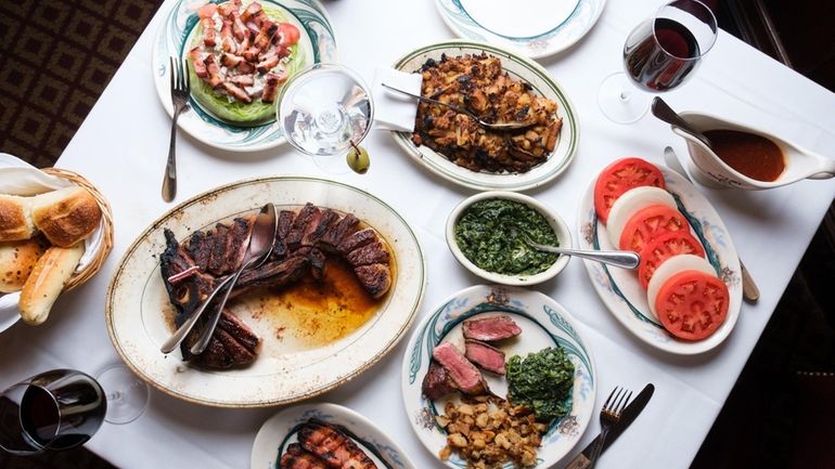 A Porterhouse steak for two surrounded by and iceberg wedge...