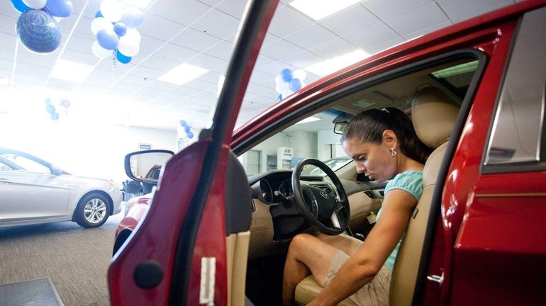 Rita Iannuzzi, of Smithtown, checks out a Hyundai while helping...